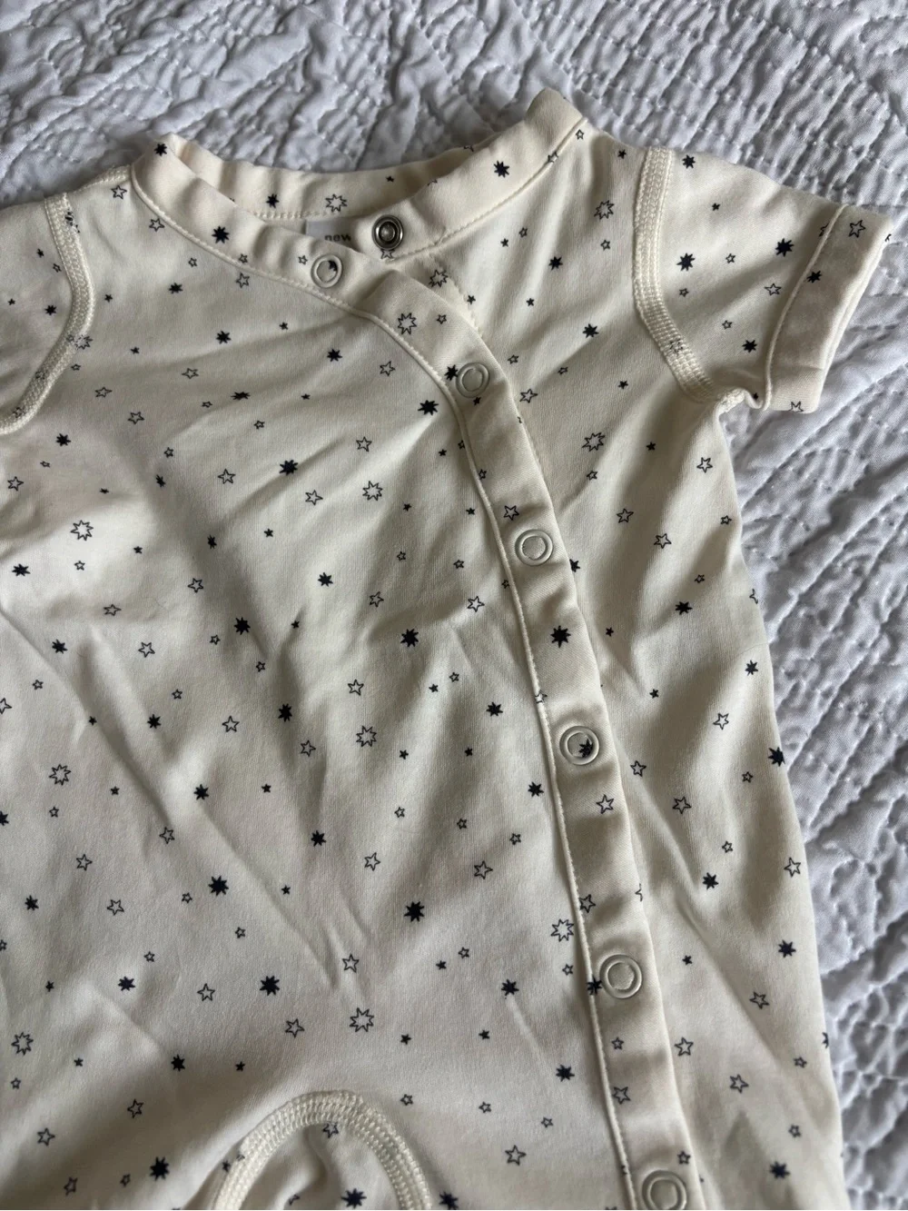 Hanna Andersson Cream Newborn Jumpsuit with Black Star Print